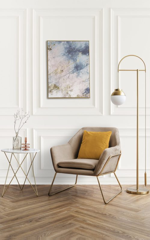 Picture frame by a velvet armchair